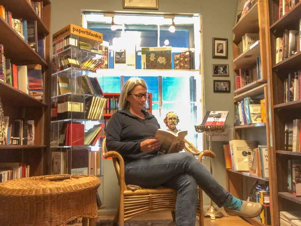 Salt Lake City bookstores: King's English bookshop. Woman in chair reading a book