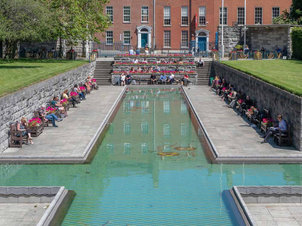 Dublin garden of remembrance- pool with people sitting eating lunch