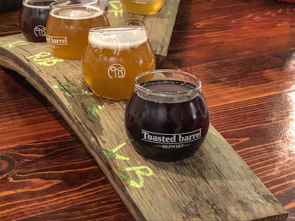 SLC Breweries: Toasted Barrel Brewery. Beer sampler on a wooden board