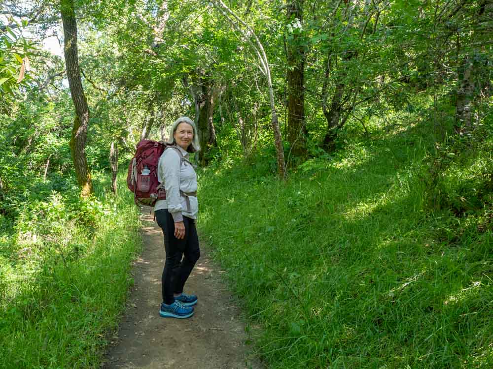 El Camino de Santiago packing list- hiker with pack in forest