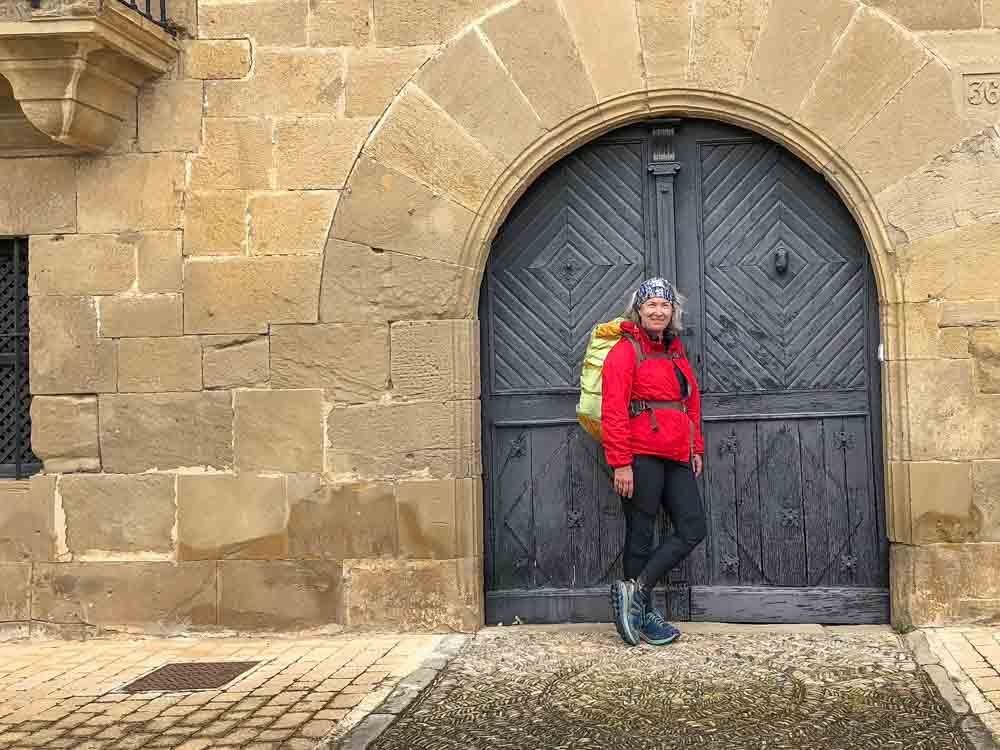 Camino de Santiago portrait. Red jacket and backpack