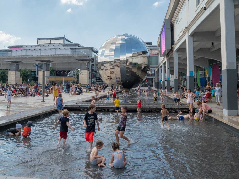 Bristol England harbor area in summer with kids playing
