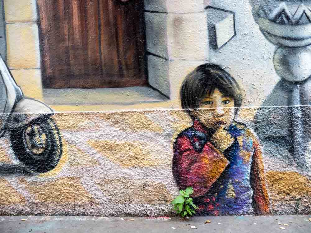 Paris street art mural of a small boy