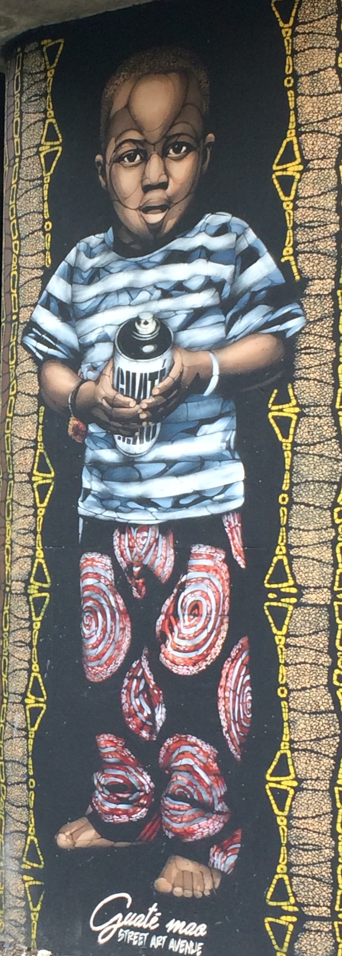 Saint Denis canal street art in Paris: Guate Mao portrait of a boy