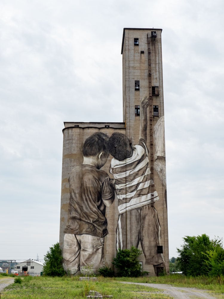 Guido Van Helten mural in Nashville- of two kids on a silo