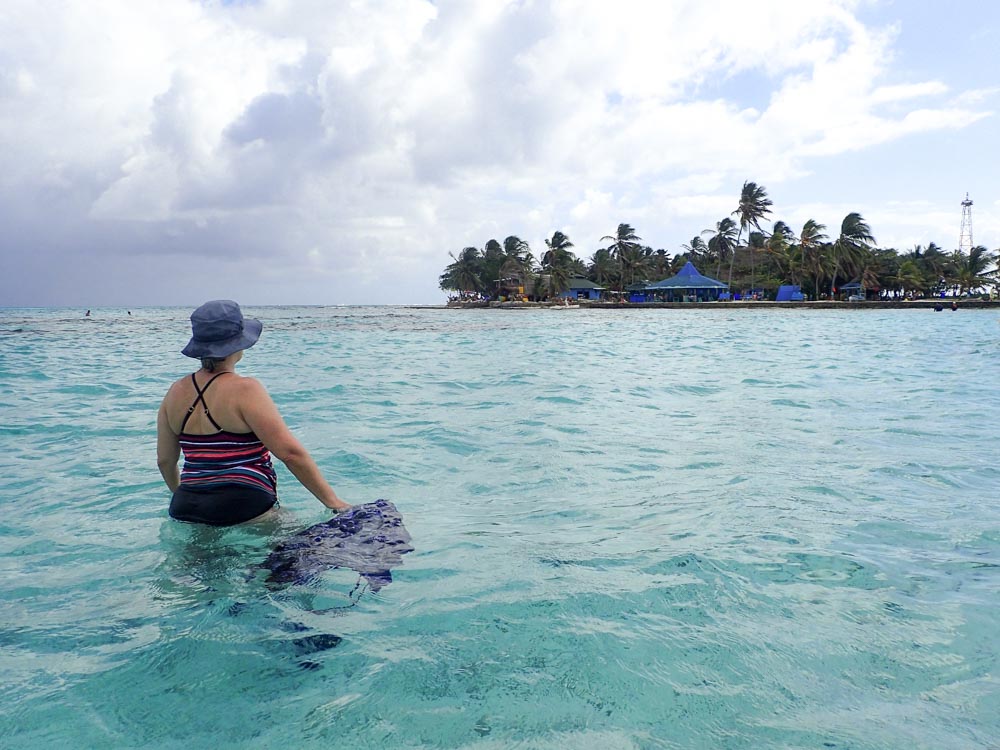 San Andr&eacute;s Colombia woman in water walking to Haynes Cay