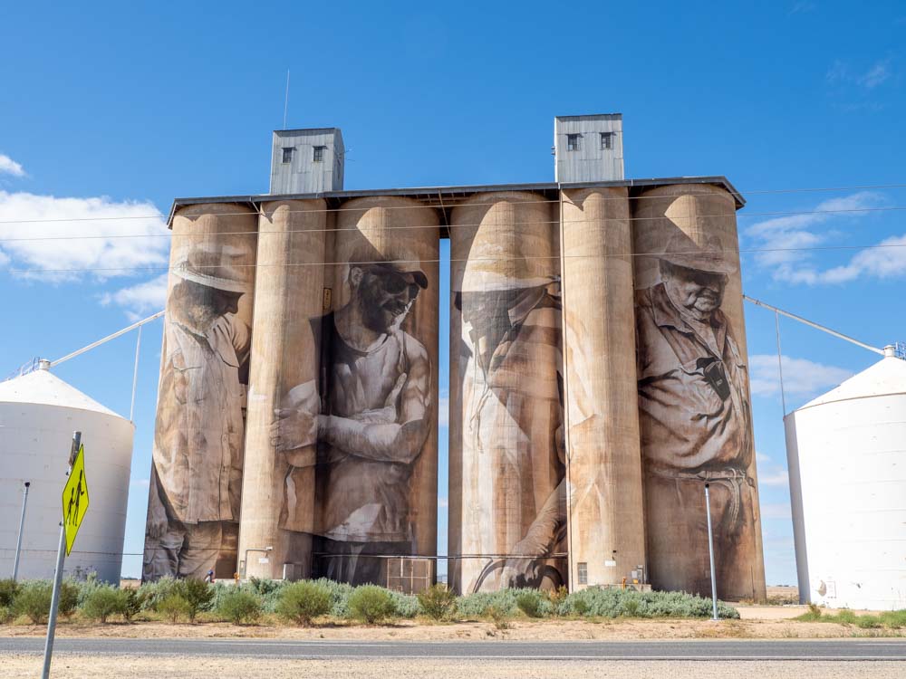 Brim silos by Guido Van Helten. Four grain silos with farmer murals