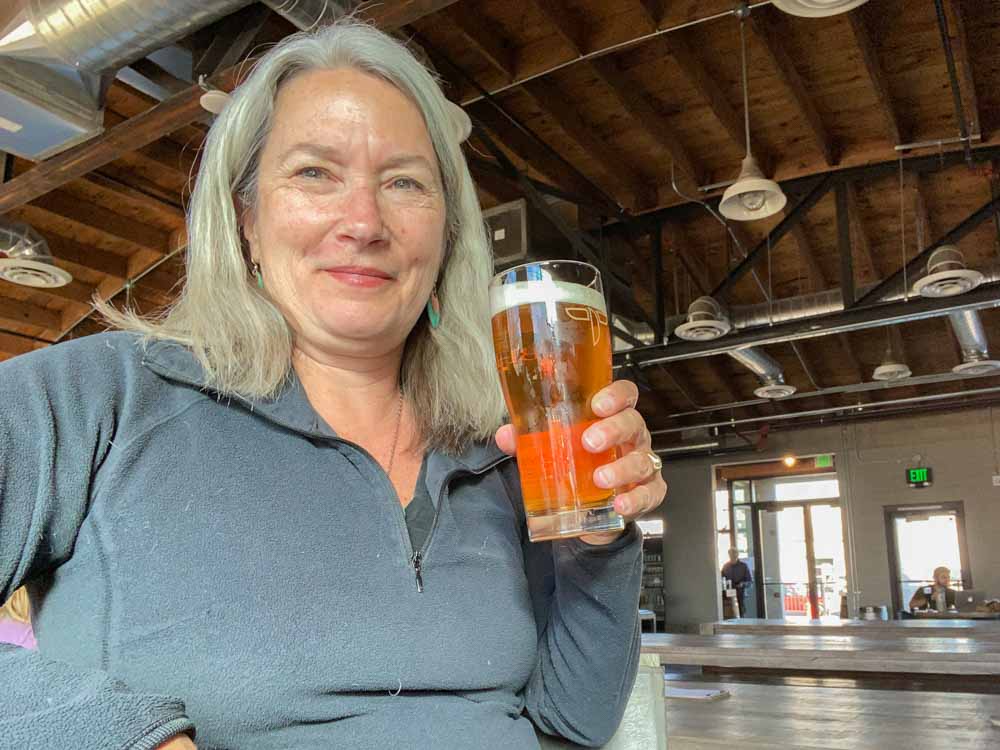 Templin Family Brewing. Woman drinking a pint of beer