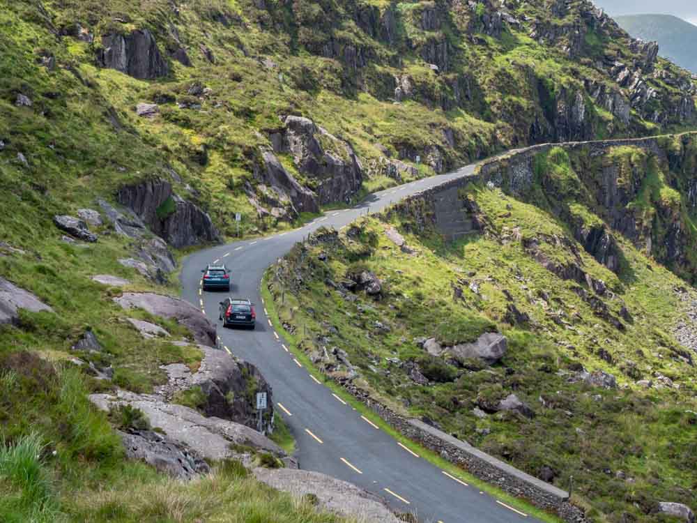 Driving in Ireland on the Conor Pass. Two cars on narrow mountain road
