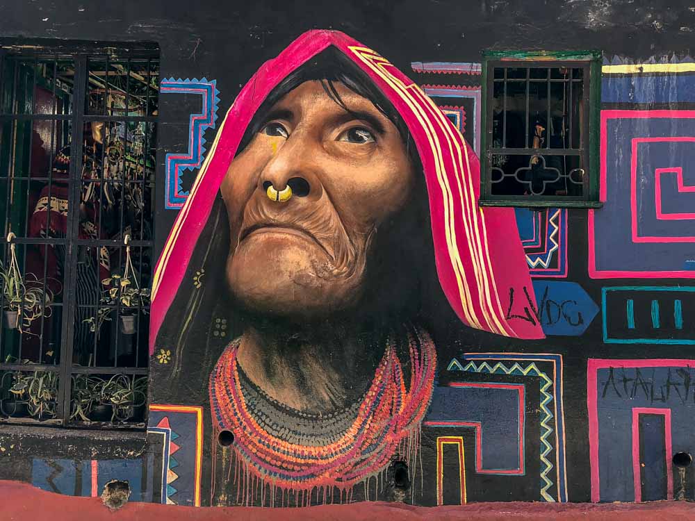 Street art Bogota- mural by Carlos Trilleras. Indigenous woman wearing a scarf and nose ring