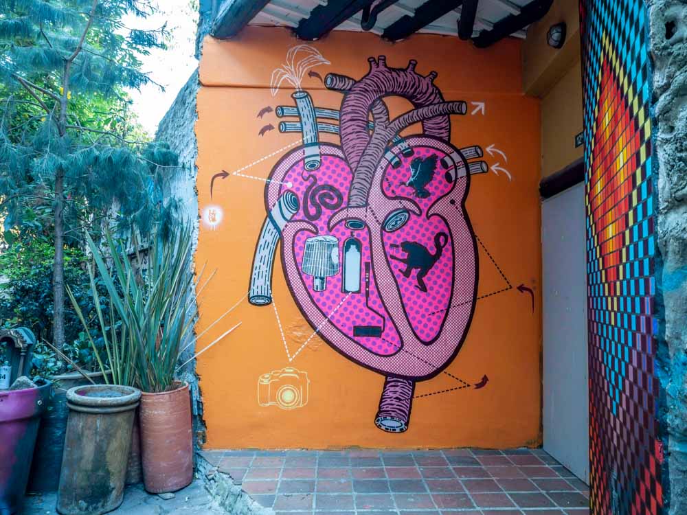 Mural at Bogota Casa Graffiti- pink heart on orange background