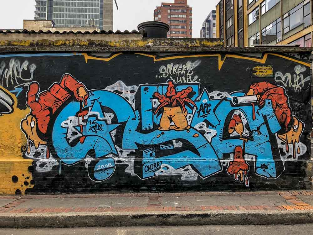 APC Crew Bogota Graffiti. Blue lettering on black background