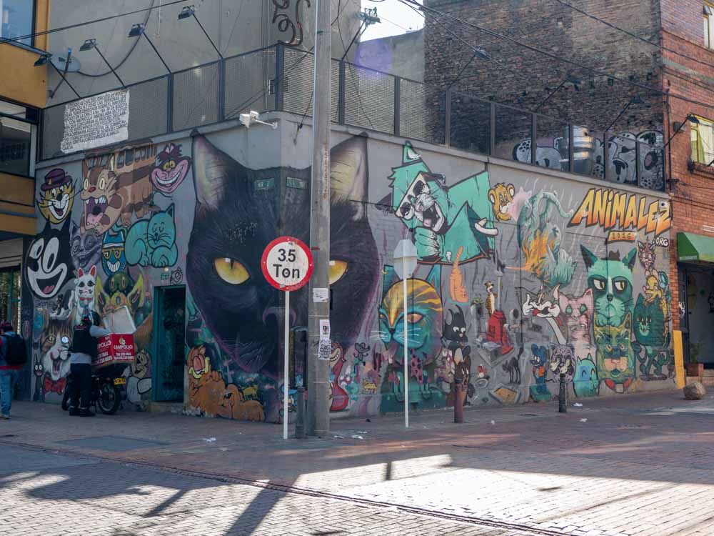 Mural in Bogota- cats by ION totles, Multiple cats on two exterior walls