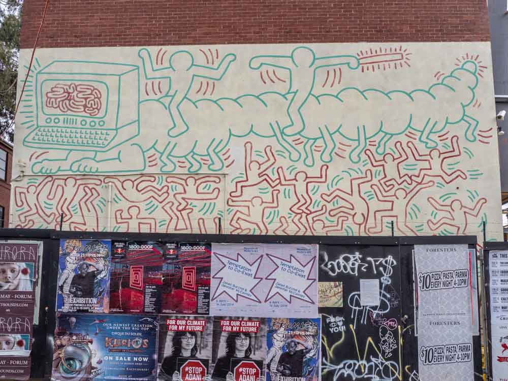 Keith Haring mural in Melbourne's Collingwood. Green and red characters
