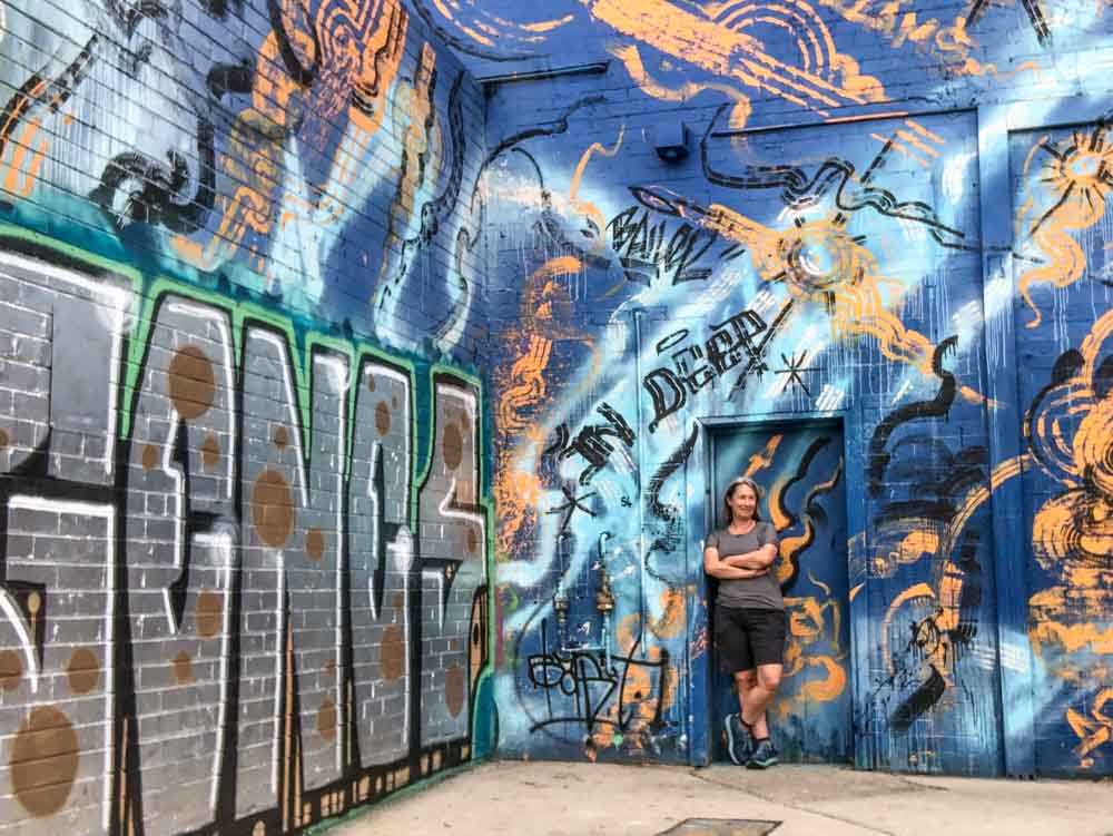 Prahan artist lane parking lot graffiti. blue and silver paint with a woman