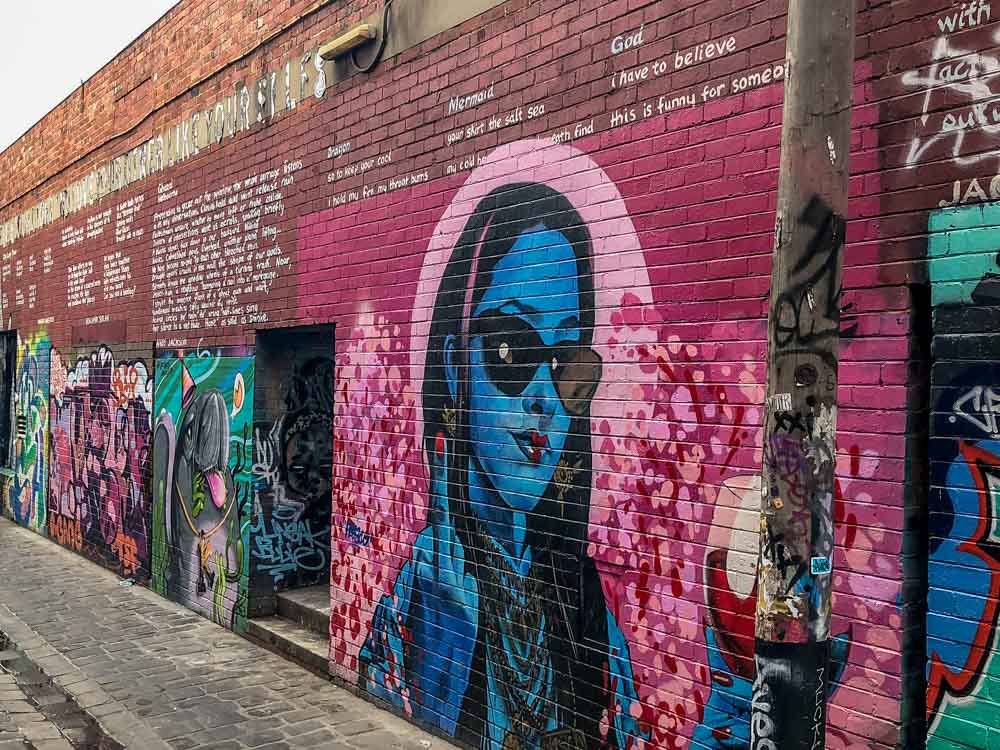 Prahan Melbourne Artist Alley. Spray painted murals in blue and pink and words