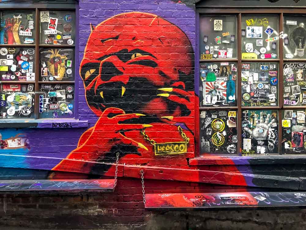 Heesco mural in melbourne. Red monster with purple background