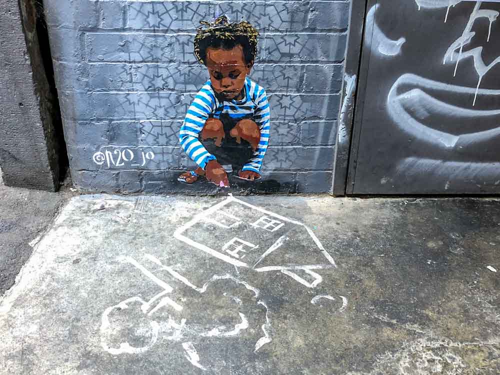 Graffiti Lane Melbourne: N2OJo stencil - boy playing with toys