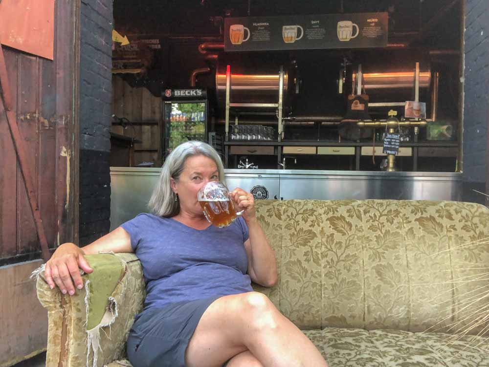 Berlin Bergit and Bier beer garden- woman sitting on a couch drinking beer