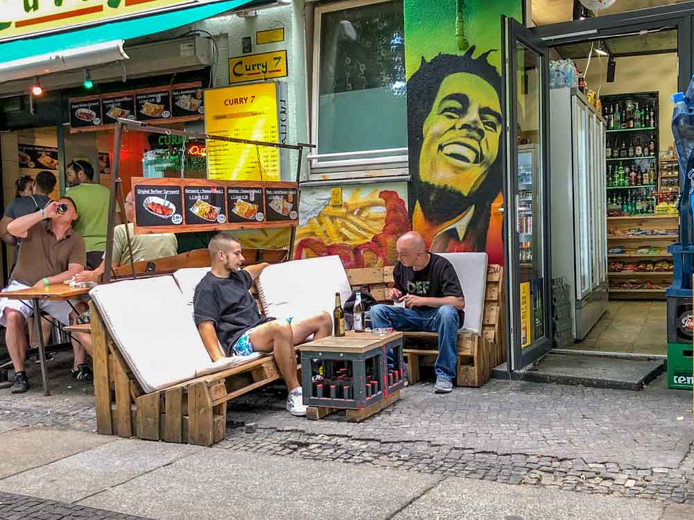 Berlin Kreuzberg convenience store with men having drinks