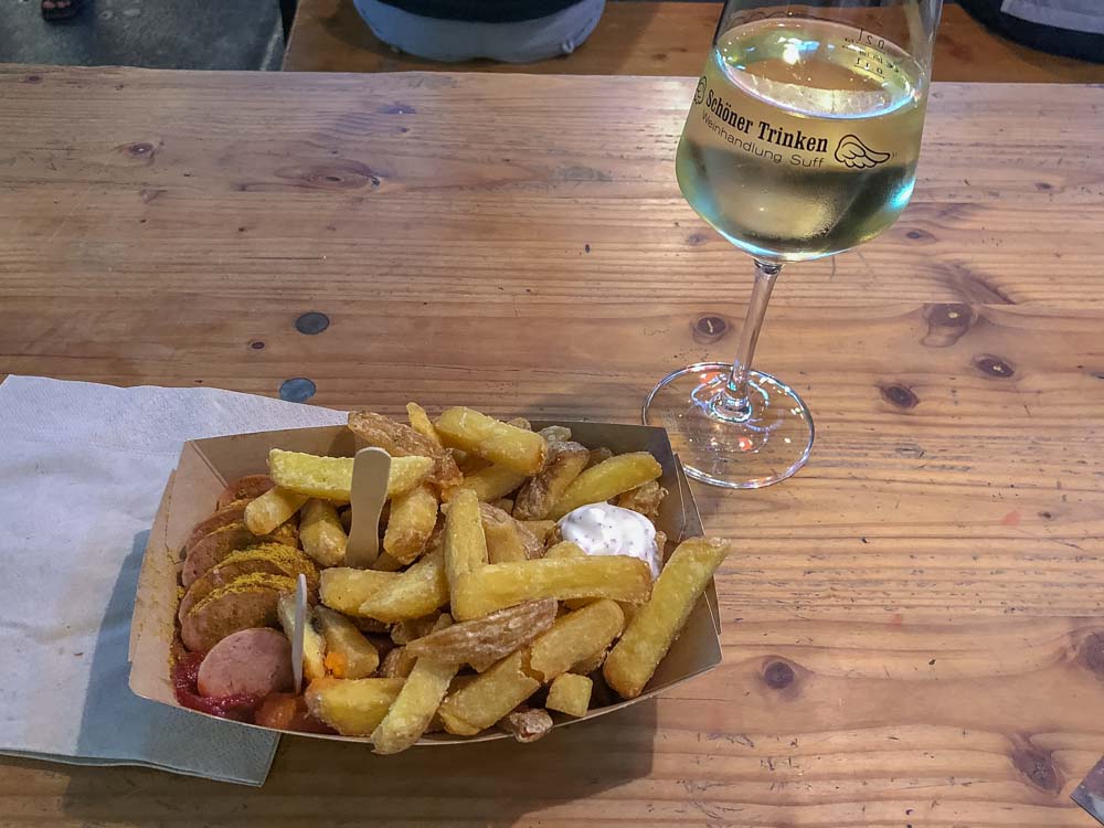 Currywurst in Berlin Germany- platter of sausage with french fries and white wine