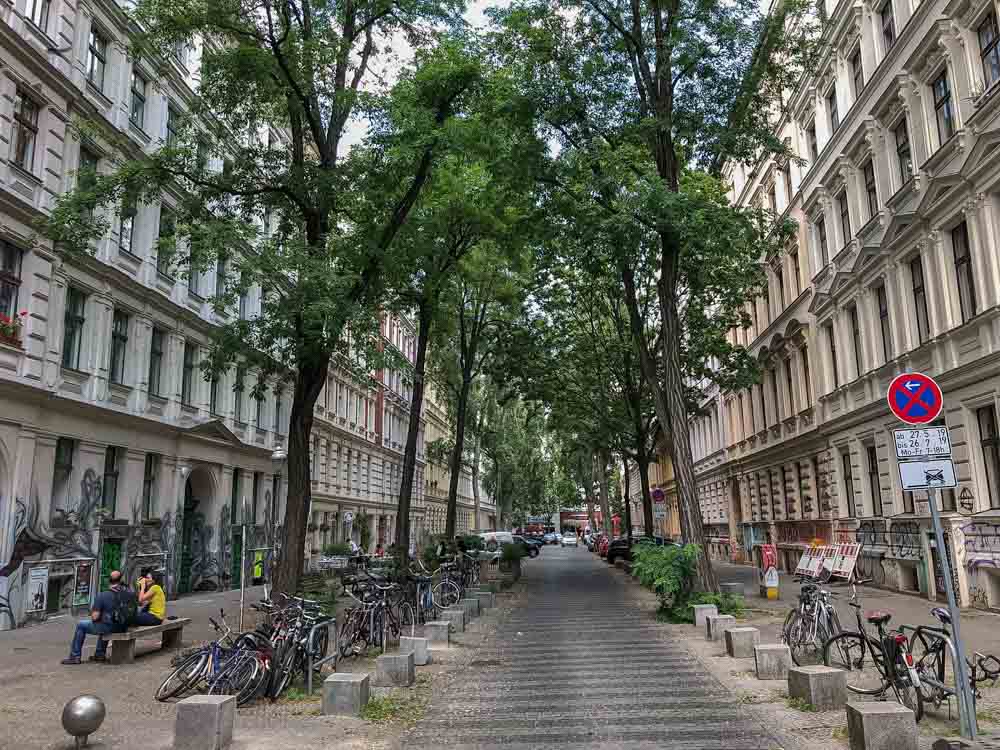 Kreuzberg Berlin street with trees, cars and a road
