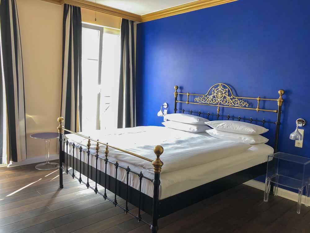 The Dude Berlin Mitte hotel with bed and blue wall