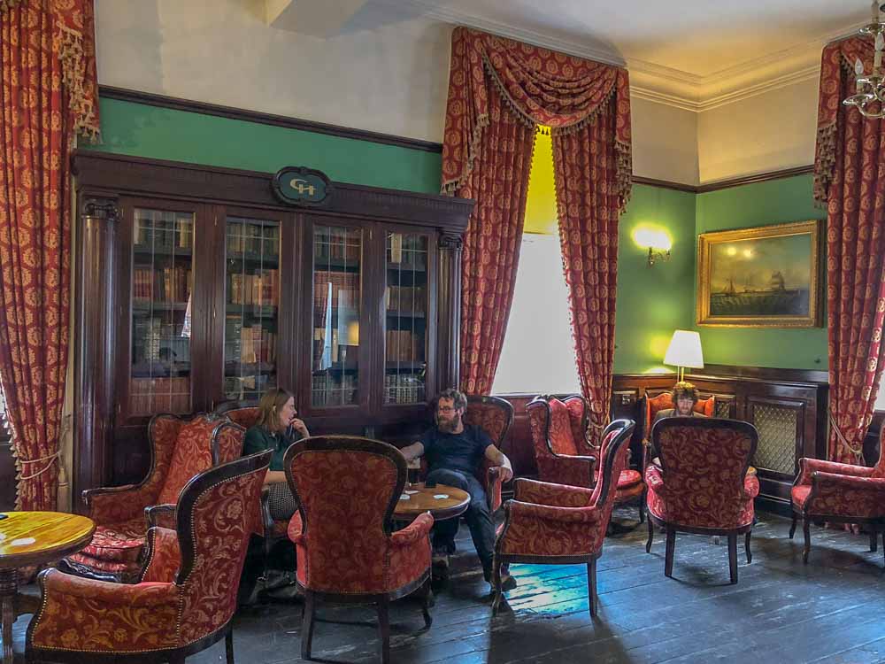 Library Bar in Dublin Ireland. bookshelves table and chairs