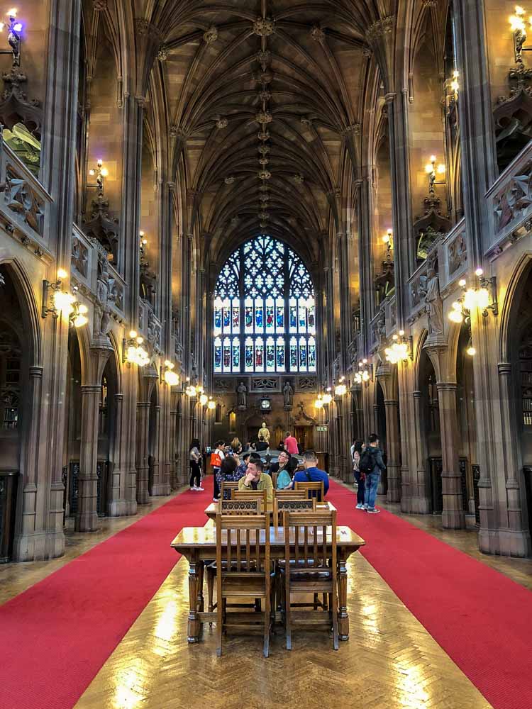 Manchester John Rylands Library. vaulted room desk chairs and red carpet