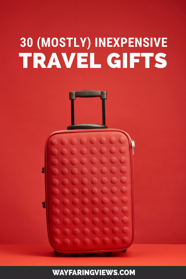 Useful small and nexpensive travel gifts. red suitcase with red background