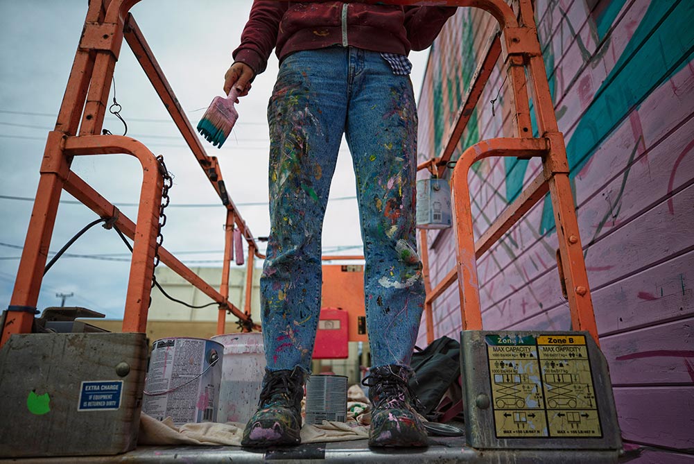 Eureka California street art festival. Legs and painted jeans on scaffolding