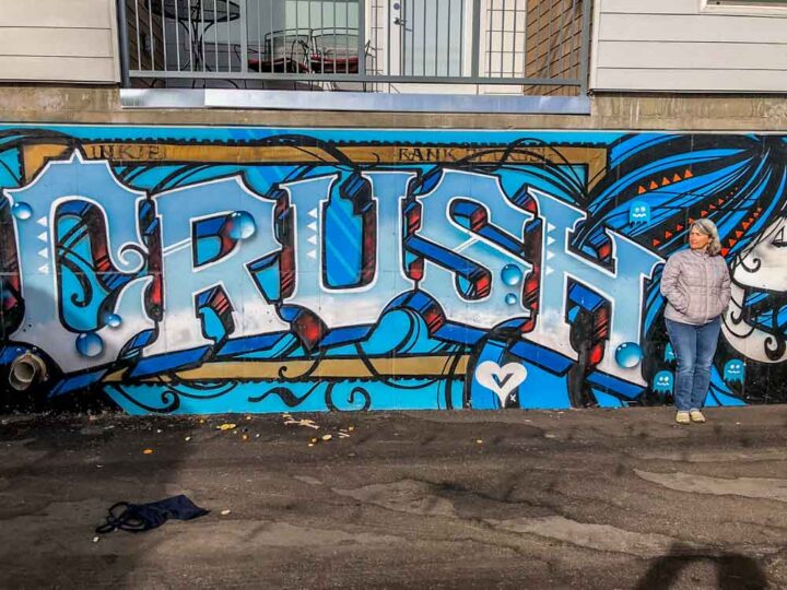 Denver Crush street art festival mural. Blue paint with woman on city street