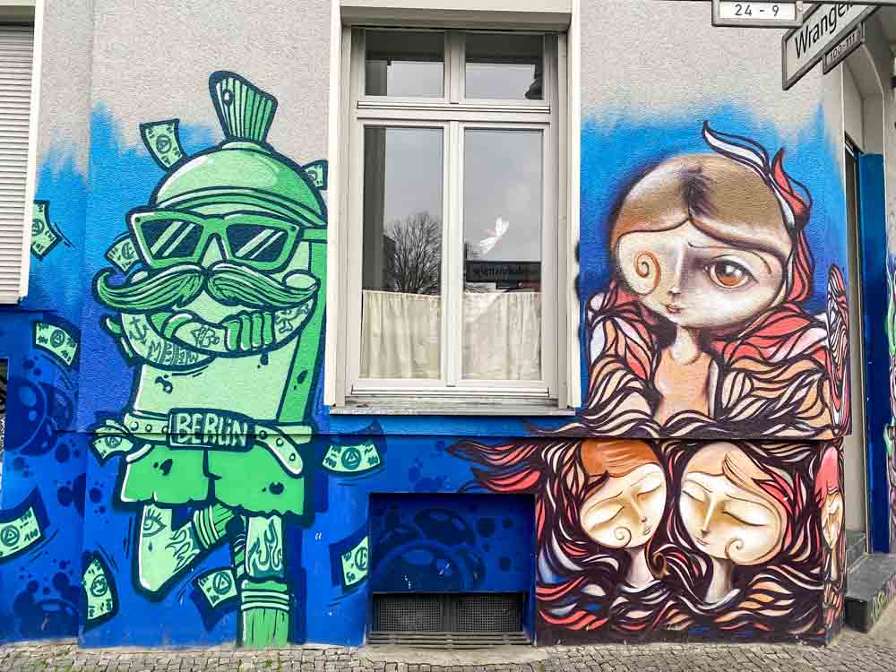 Kreuzberg Berlin Graffiti. Green man and red woman mural