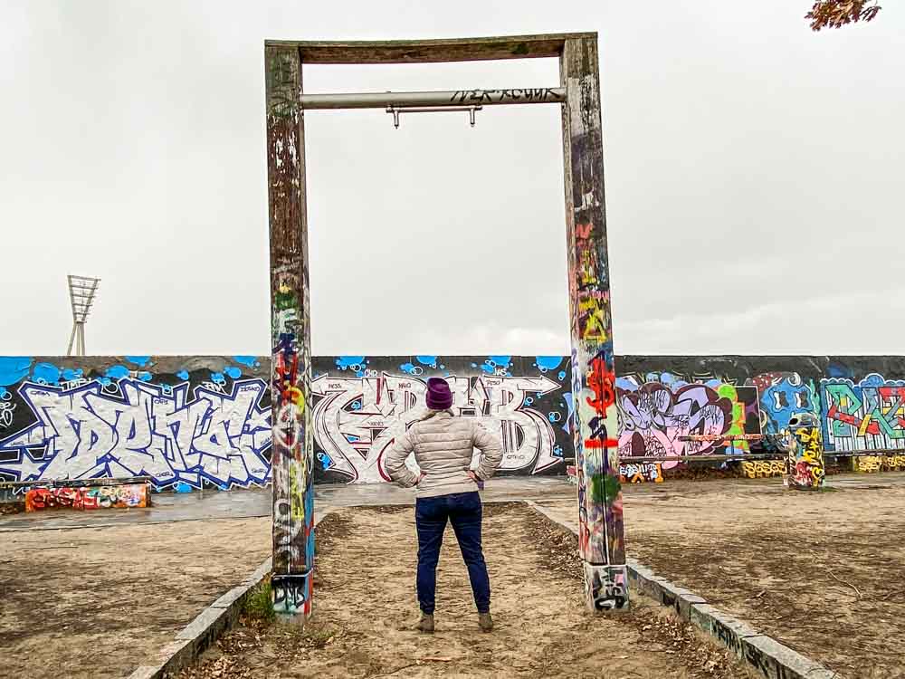 Berlin Germany Mauer Park graffiti practice wall. Woman standing framed