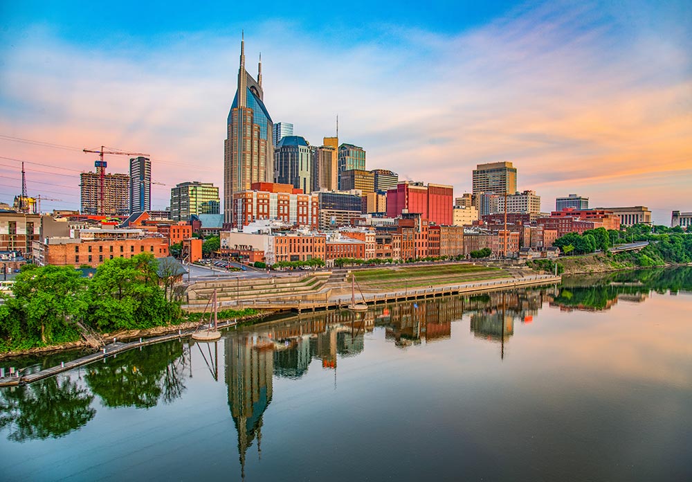 Nashville City skyline dusk. buildings and water reflection