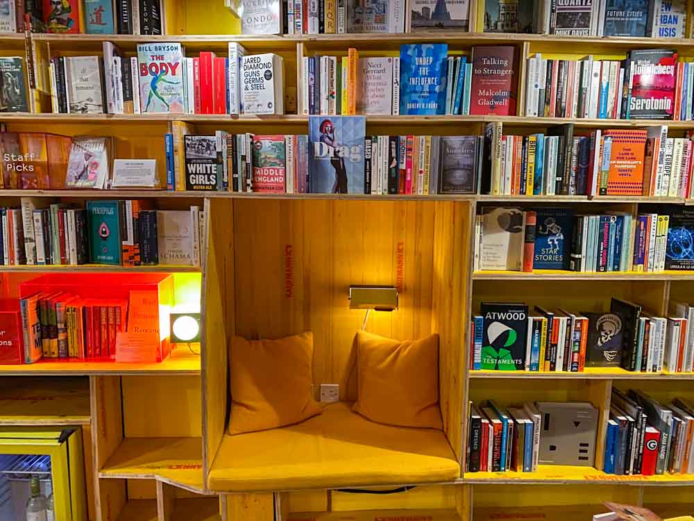Libreria Bookstore in Shoreditch London. books with bench, pillows and lighting