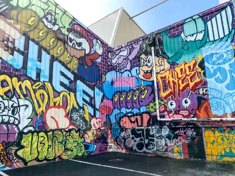 Kakaako Hawaii Graffiti: OG Slick CKAweeks, Mung Monster. Multicolored spray graffiti