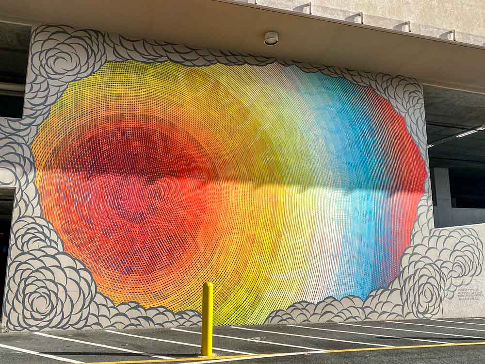 Ascholz mural in Honolulu for POW!WOW! Swirl design with red yellow and blue