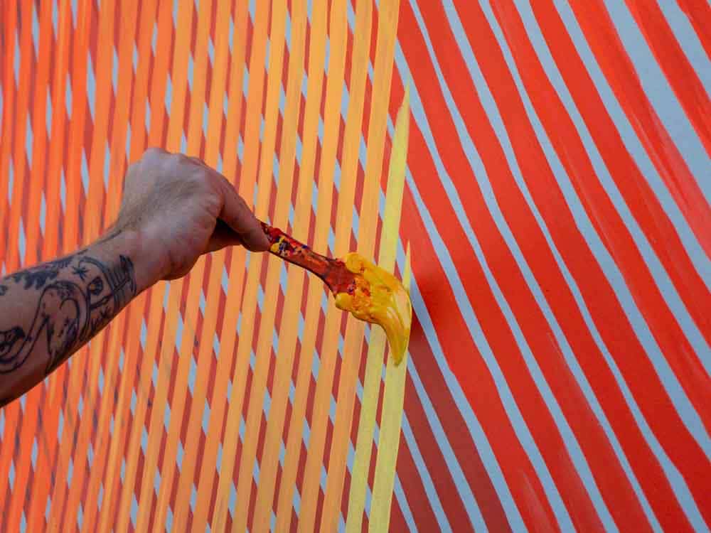 Andrew Schoultz at work on his Honolulu mural