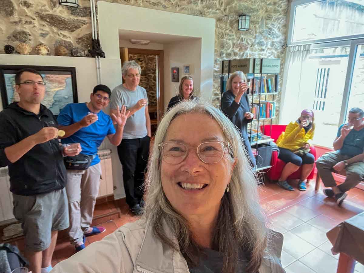 Ferreria Camino Primitivo albergue with group drinking wine
