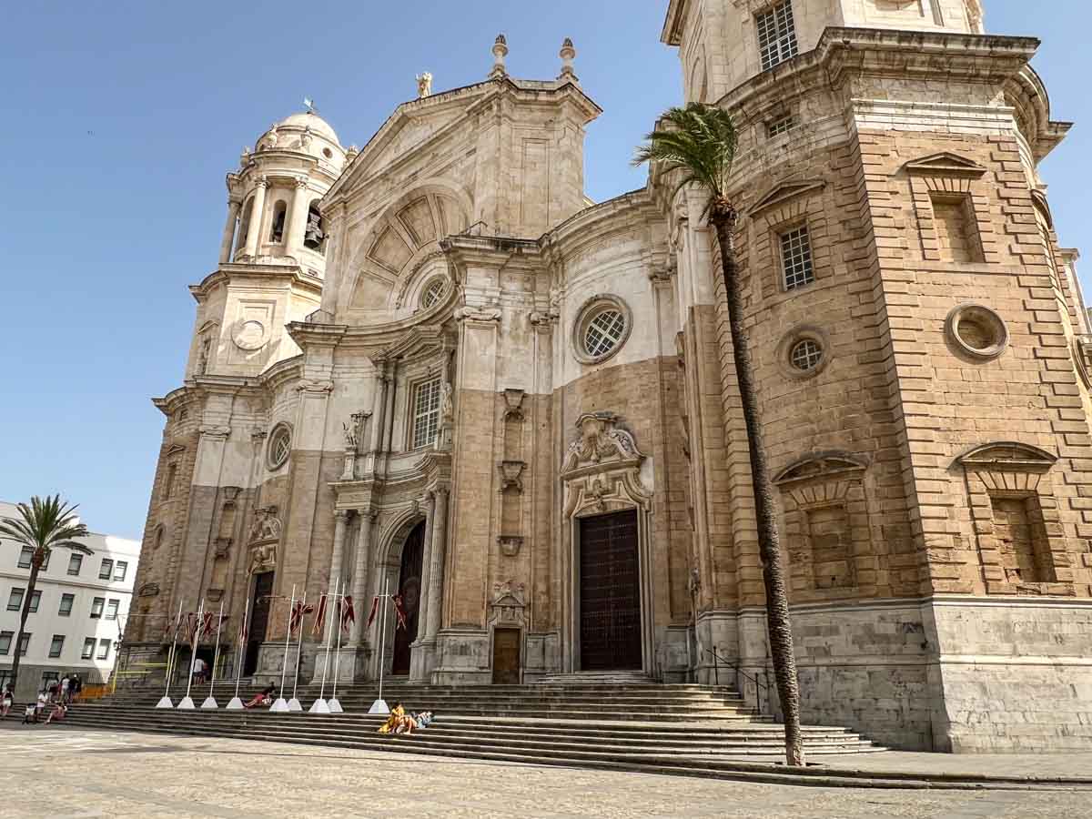 Cádiz cathedral exterior, with stone facade and steps.