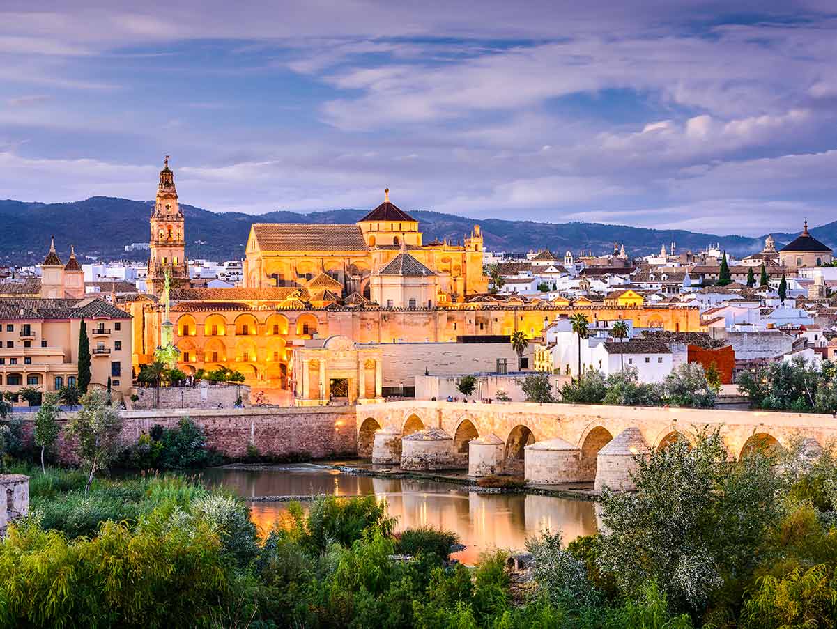 Cordoba Spain at night, with historic buildings and bridge
